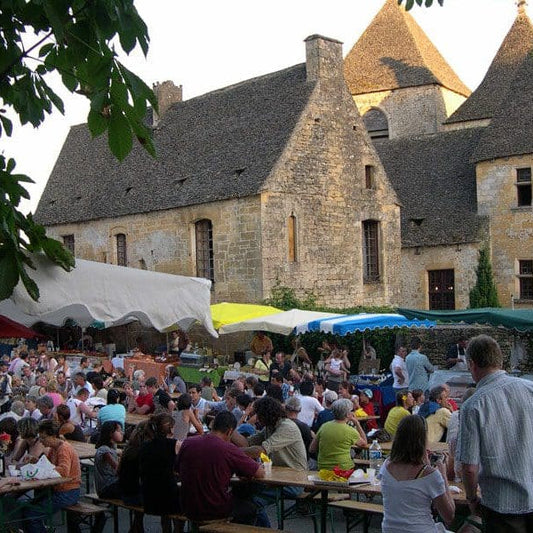 Festival in France people on tables and chairs with a beautiful castle in the background