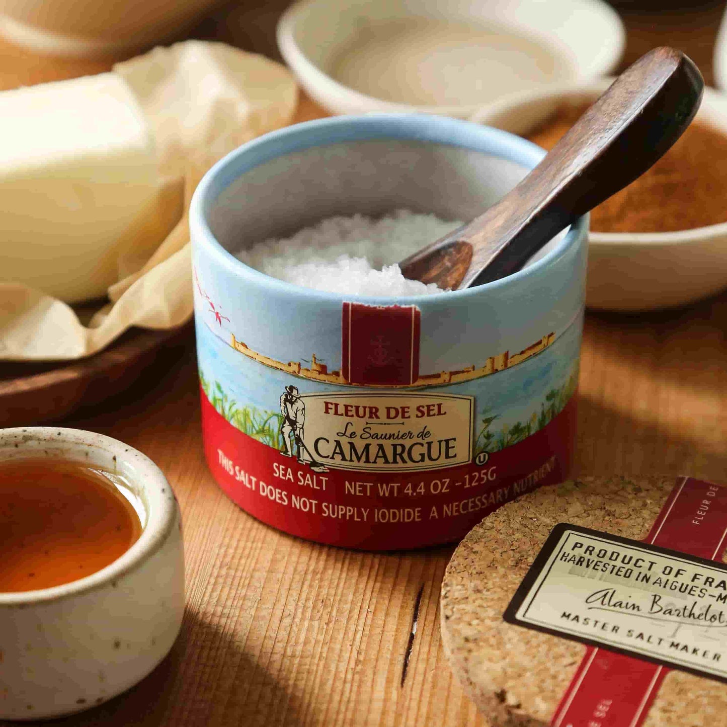 Fleur de Sel salt box on a wooden table with different spices
