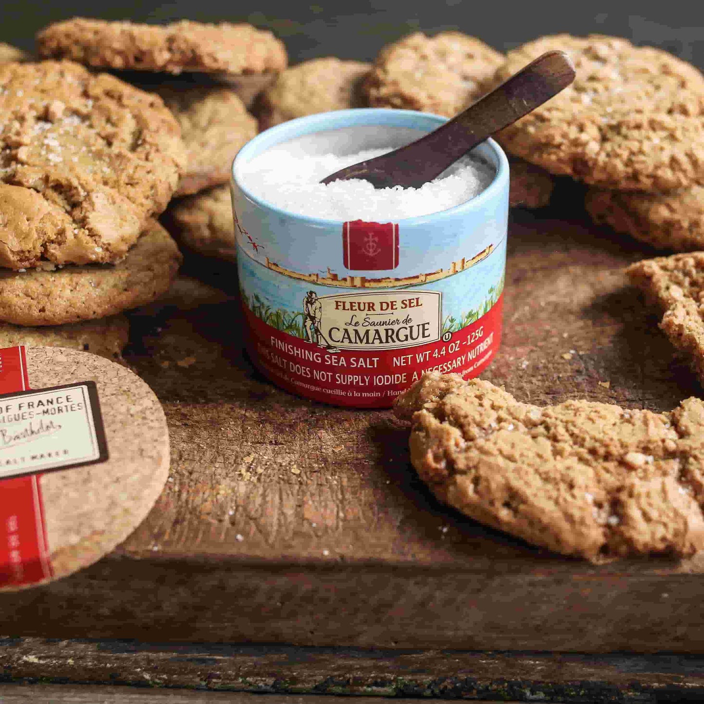 Fleur de sel salt box on a wooden table with homemade cookies