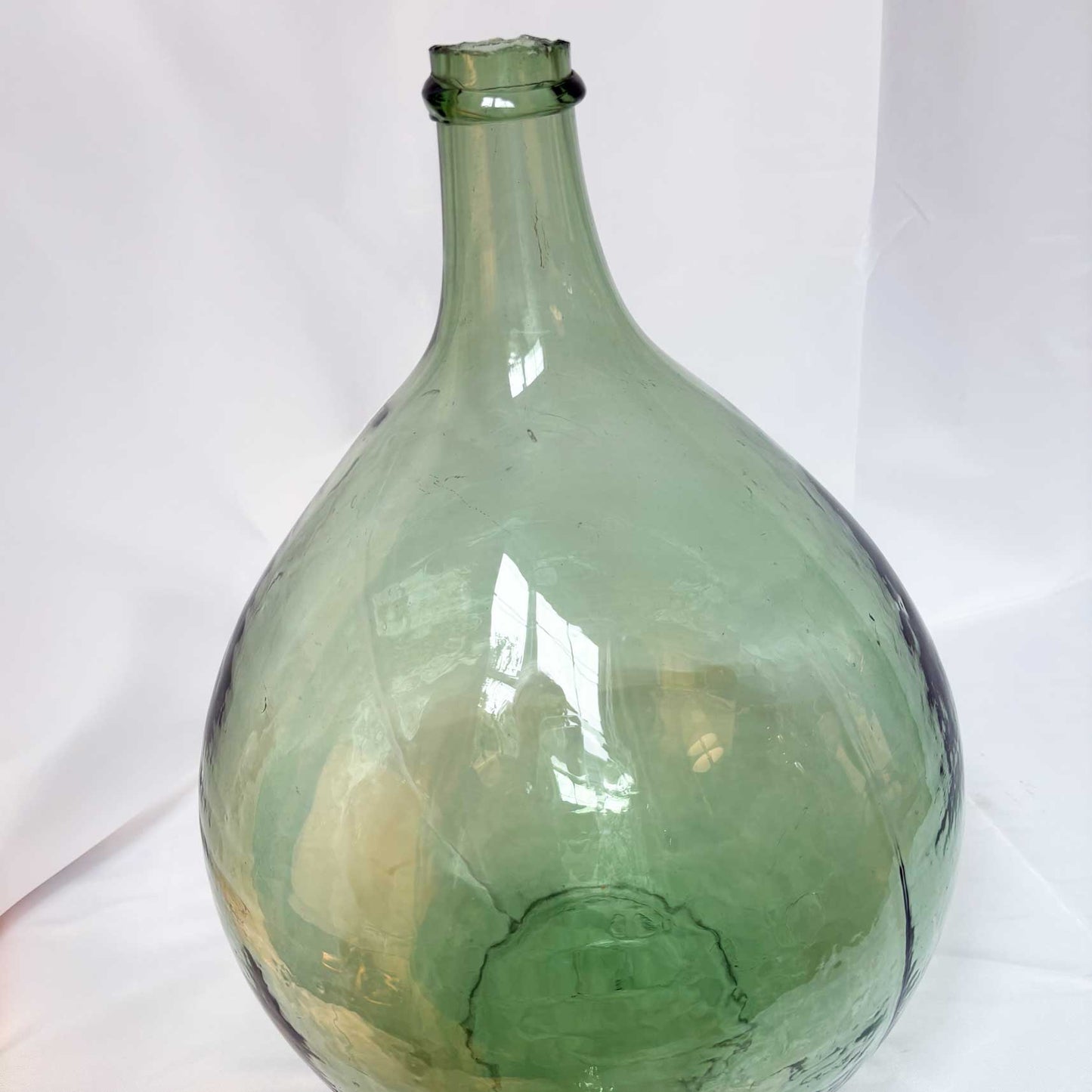 Green glass bottle on a white background