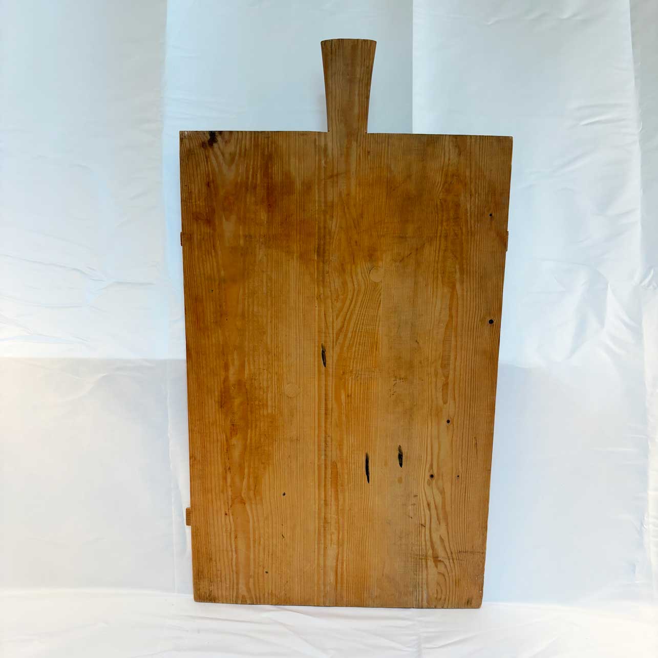 Wooden cutting board with a handle on a white background