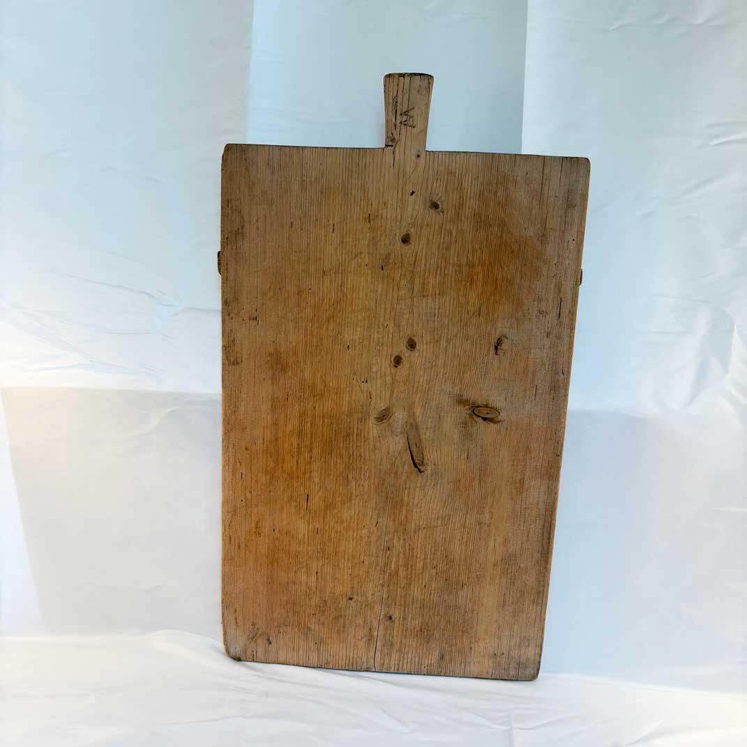 Vintage wooden cutting board with a handle on a white background