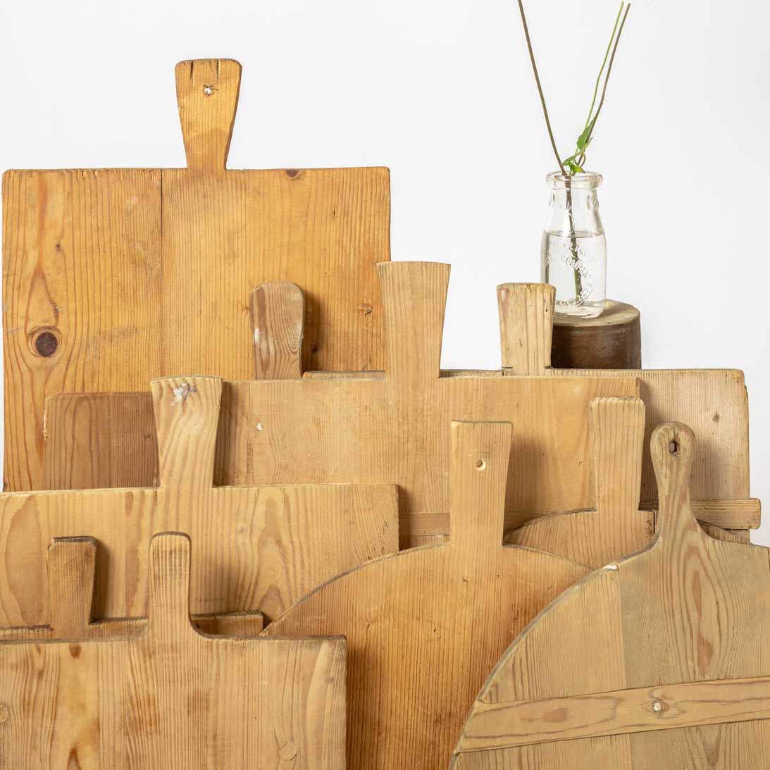 Set of wooden cutting boards with handles on a white background