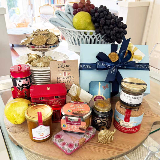 Assorted food items and gift boxes on a wooden board