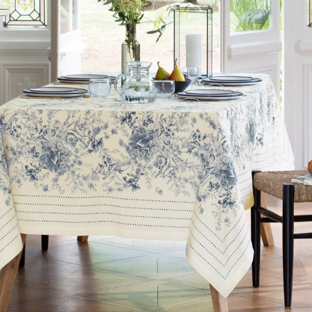 French Cotton Table Runner From France Dining table set with a floral tablecloth in a bright room