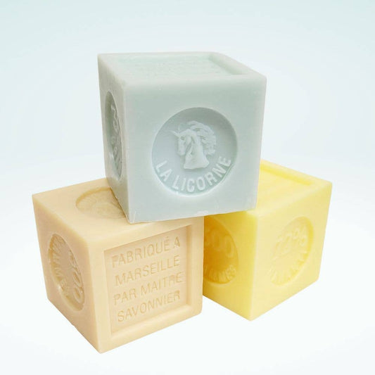 Three soap bars with 'La Licorne' branding on a light blue background