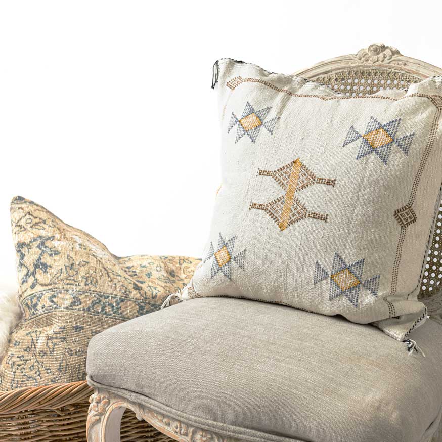 Decorative pillow with star patterns on a chair with a white background