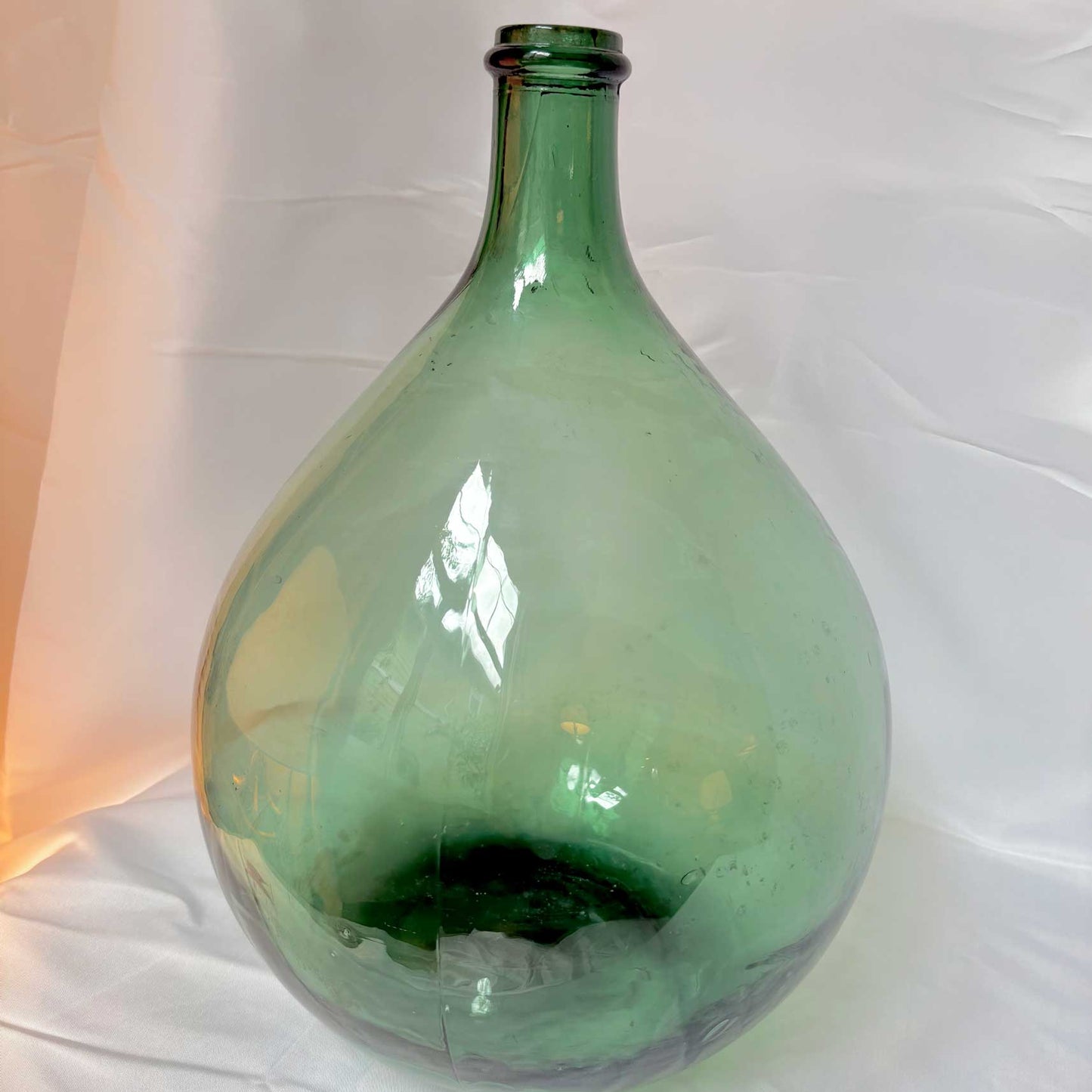 Green glass bottle on a white background