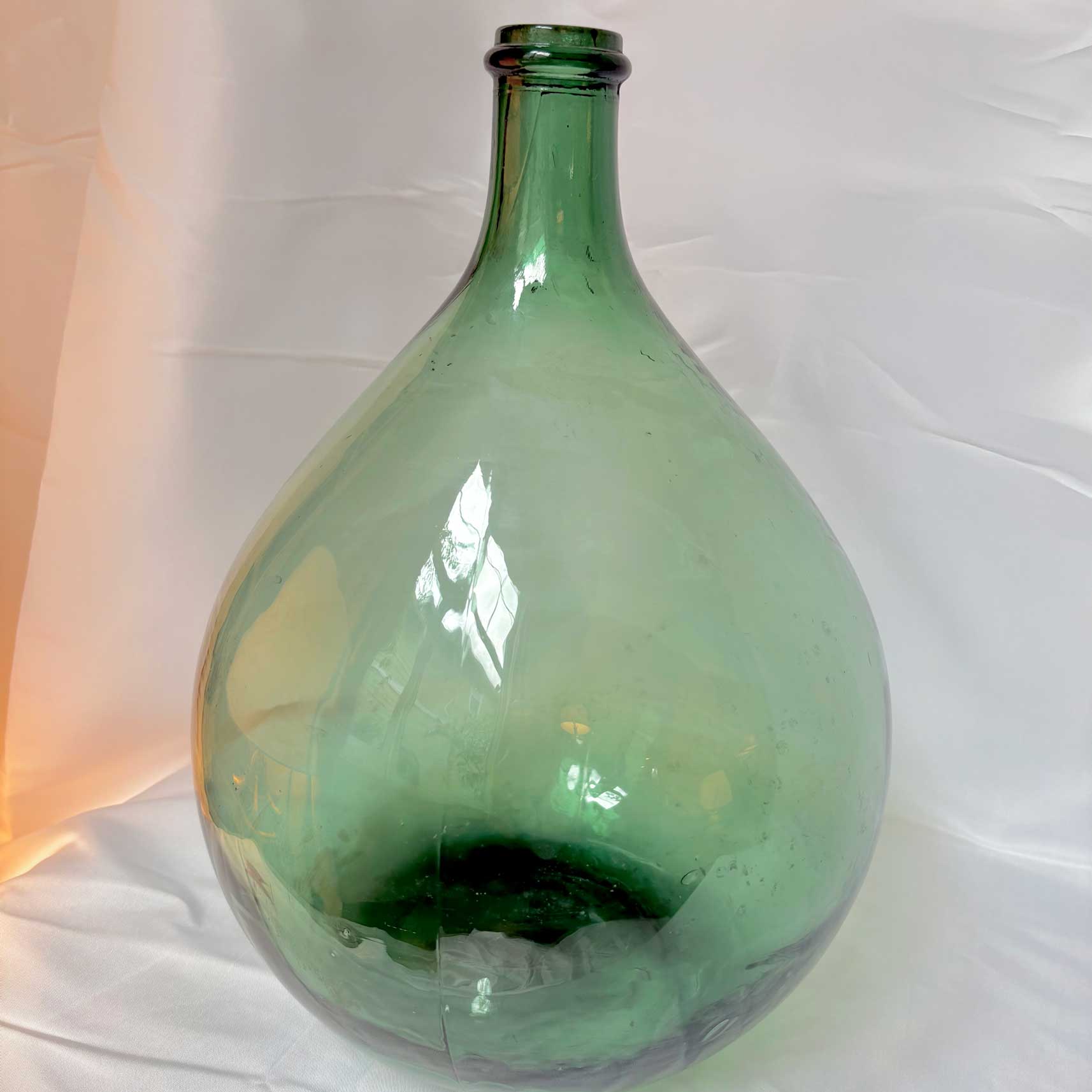 Green glass bottle on a white background