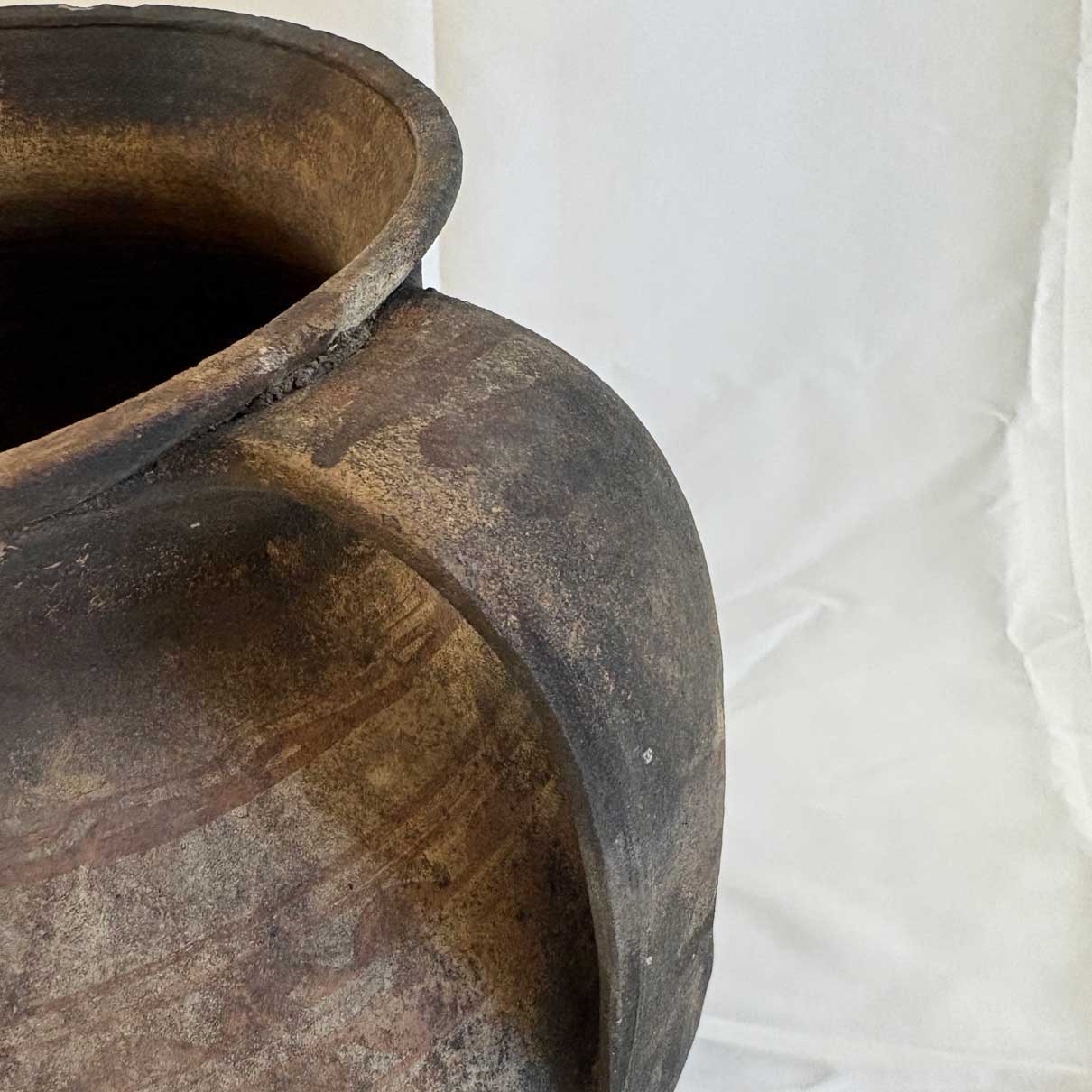 Close-up of a worn-out pot against a white background