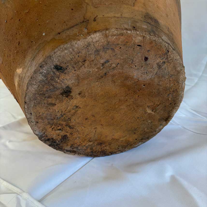 Close-up of a worn wooden stool on a white background