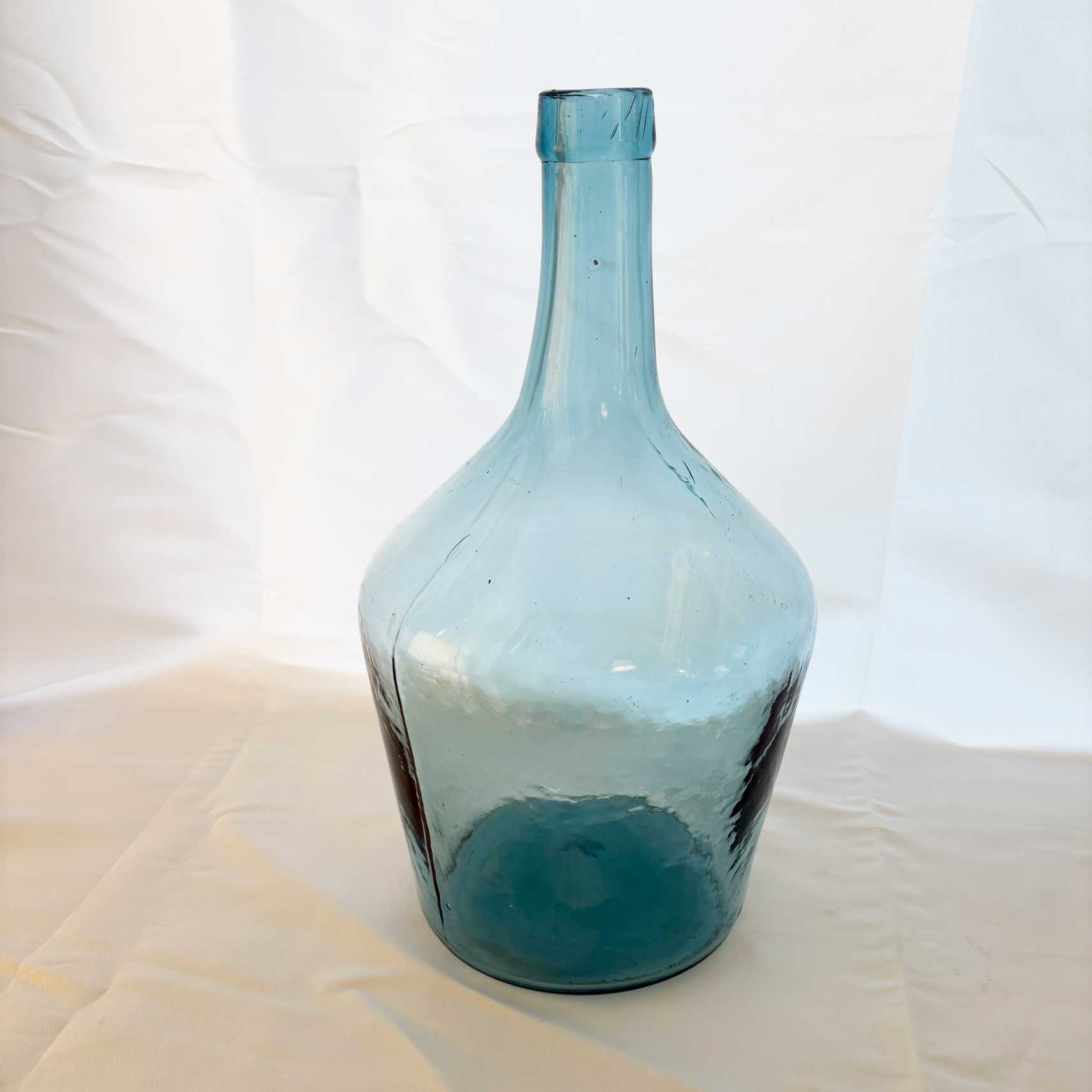 Blue glass bottle on a white background