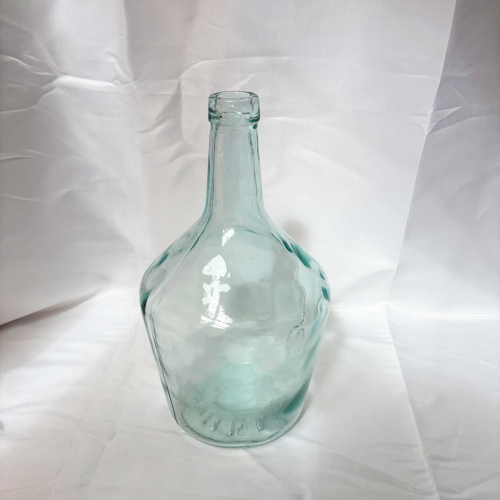 Clear glass bottle on a white background